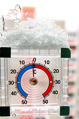 Image showing thermometer with layer of snow showing two degrees