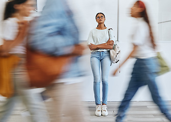 Image showing Anxiety, fear and a woman in busy crowded university sad and thinking. Stress, doubt and depression, student in hallway before interview, exam or class. Motion blur, people and girl waiting in lobby.