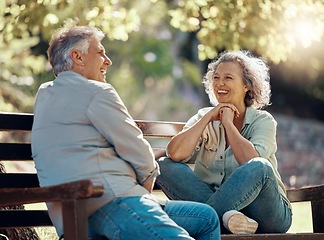 Image showing Park bench, couple and senior people with love and happiness in nature enjoying summer. Happy smile of elderly woman and man retirement together relax laughing outdoor having a fun conversation