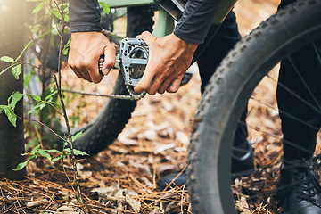 Image showing Cycling, maintenance and hands of man with mountain bike fix, service or repair wheel gear, chain or tire equipment. Nature race, adventure journey and person working on bicycle for travel in forest