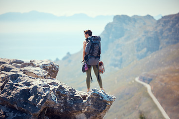 Image showing Hiker, adventure and mountain top of a woman in rock climb, view and backpacking in nature. Active female traveler on trekking or hiking journey standing on cliff with beautiful view of the outdoors