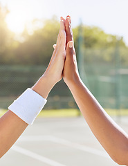 Image showing Hands, high five and people on a tennis court with motivation, success and partnership. Closeup of support, unity and diverse friends on a field for team building, training or sports match win.