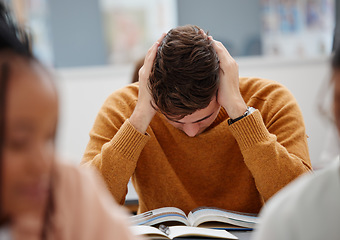 Image showing University, study and tired student reading book in class while studying for test or exam. Education, stress and burnout man with headache, knowledge and scholarship learning college work in library.