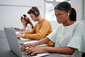 Image showing Students, elearning and laptop in classroom education, learning and studying with technology indoors. Focused woman typing research essay or project on computer at university, college or school