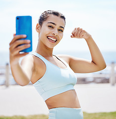 Image showing Phone selfie, fitness girl flexing arms, happy smile for workout, exercise or training by beach. Exercise, training or sports health influencer woman for wellness motivation for 5g social media post