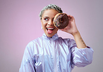 Image showing Fashion, donut and black woman excited and happy about dessert with futuristic vaporwave or holographic style clothing against purple background. Face of a happy female model looking cool and trendy