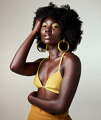 Image showing Black woman, beauty and fashion, makeup or hair care and gold jewelry on gray studio background. Portrait, hand in afro hair and skincare cosmetics model from Jamaica posing for female empowerment.