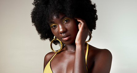 Image showing Black woman, face and makeup with skincare beauty and cosmetics against grey backdrop. Model, hand and hair, show afro, skin wellness and health in portrait against studio background in Los Angeles