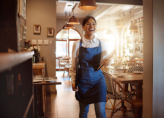 Image showing Woman, happy and waitress in restaurant working in apron with food menu in hand for table. Girl, smile and service work at luxury diner, cafe or coffee shop show happiness on face for job in London