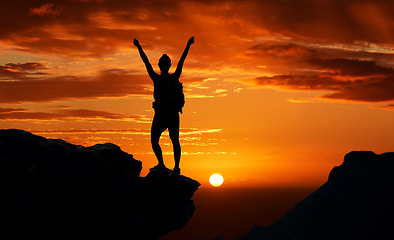 Image showing Freedom, mountain and man silhouette hiking at sunset, happy and success celebration in nature. Motivation, health, and energy by a backpacker shadow after adventure and trekking expedition with joy