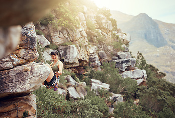 Image showing Mountain, rock climbing and sport with a sports woman and climber abseiling outdoor in nature. Fitness, exercise and health with a strong female athlete training or in a workout in the mountains