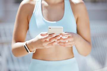 Image showing Hands of exercise woman typing on a phone, check fitness app or step tracker for exercise support on training run. Sports, marathon runner or workout girl with digital tech for help on cardio running