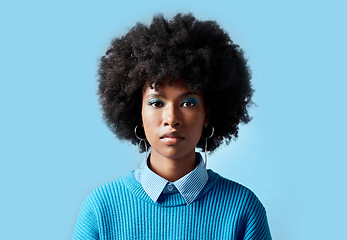 Image showing Black woman afro, portrait and serious face for vision in focus against a blue studio background. African female model in cool fashion with cosmetic eyeshadow makeup on mockup