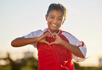 Image showing Heart hand and girl portrait at soccer game with passionate and happy sports player in Mexico. Mexican child football athlete in match showing appreciation, happiness and joy with love shape.