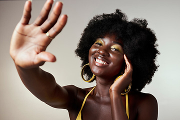 Image showing Black beauty, hand and woman with yellow makeup, face cosmetics and eyes shadow for glamour. Good skin, afro hair and smile for portrait of happy African girl with vintage, retro and funk fashion