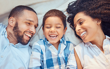 Image showing Parents, child and smile in bed for happy closeup together to relax together at family home. Mother, dad and kid laughing after comic, funny or silly joke show happiness on blanket at their house