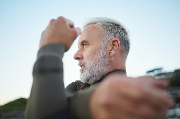 Image showing Fitness, surf and stretching with a mature man getting ready to go surfing as a workout or training. Sports, exercise and health with a male surfer doing a warmup at the start of his cardio routine