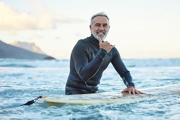 Image showing Senior man surfing in Hawaii beach, surf culture hands signal and healthy fitness in ocean nature. Friendly surfer easy greeting, retirement travel of elderly person and sea adventure lifestyle