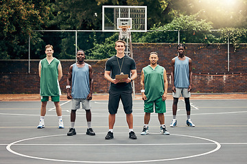 Image showing Basketball, sport and team with a coach training his players on a court outdoor during summer. Teamwork, fitness and exercise with a sports group of male athletes ready for a workout or game