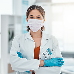 Image showing Covid, medical and trust with doctor and arms crossed with a face mask in hospital for innovation, support or vision. Medicine, trust and leadership with portrait of healthcare employee in clinic