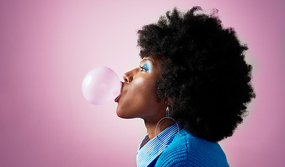 Image showing Bubble gum, afro hair and black woman on pink studio background with fashion, cool or Jamaican trend hairstyle. Profile, head or beauty model with bubblegum, makeup cosmetics and bold or fun attitude