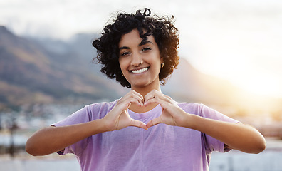 Image showing Hand, heart and woman showing love sign in a city, travel, freedom and happy student. Portrait, smile and finger gesture with cheerful indian tourist enjoying foreign exchange programme in Mexico