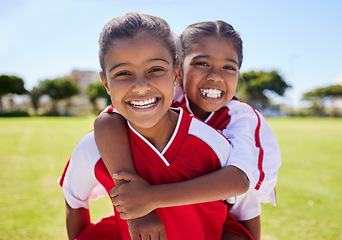 Image showing Girl, friends and portrait smile on football field having fun before training for match, game or competition. Soccer pitch, sports and kids piggy back on grass learning sports for fitness exercise.