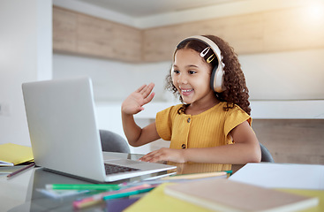 Image showing Education, laptop and girl learning a virtual class from her kindergarten teacher via an educational online website. Video call, homeschooling and happy student in headphones waving at tutor teaching