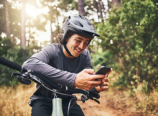 Image showing Cycling man in forest, phone gps and map direction with adventure, nature trail and bicycle break in woods. Happy mountain bike sports athlete, mobile app search and typing location guide connection