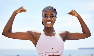 Image showing Strong black woman flexing arms, muscle and body power, fitness and wellness in urban Jamaica outdoors. Portrait proud female athlete energy, exercise and happiness of healthy bodybuilder lifestyle