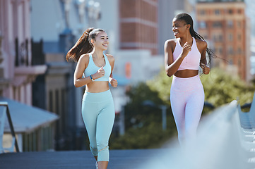 Image showing Fitness women, running and training in the city for healthy exercise, cardio and workout together in the outdoors. Athletic woman friends smile for run and exercising in a urban town for wellness