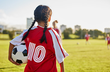 Image showing Children, sport and football with a girl soccer player on a field outdoor for fitness, exercise or training. Sports, workout and kids with a female child on grass for health, wellness and recreation