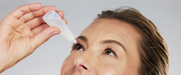 Image showing Woman with eye drops, healthcare and medicine in medical treatment. Tired eyes, glaucoma and allergy relief with zoom and macro shot of mature woman applying medical liquid for optical conjunctivitis