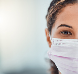 Image showing Covid, mockup and face with a woman in a mask during the pandemic for healthcare marketing or advertising. Closeup portrait of an attractive young female covering her mouth during the corona virus