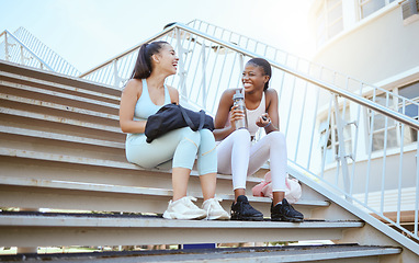Image showing City fitness, relax and friends on stairs after running for cardio with water together in Australia. African runner women with smile, laughing and happy after outdoor workout and exercise training