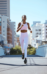 Image showing Black woman, city running and cardio fitness training, workout and exercise in urban city outdoors. Focus, motivation and wellness of strong, healthy and african sports runner athlete sprint in town