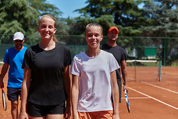 Image showing Tennis club together after hard training, showing their dedication, hard work, and teamwork.