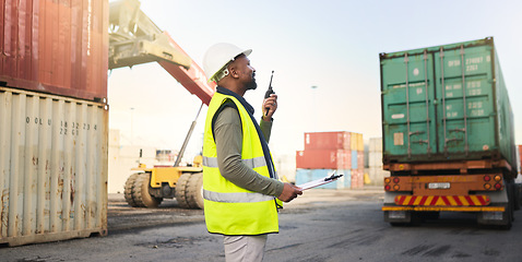 Image showing Black man working on stock, logistics and cargo delivery in the transport and supply chain industry at the shipping port. Employee with radio communication to export container for export distribution