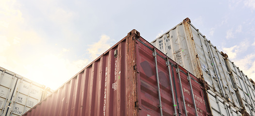 Image showing Cargo container, logistics and shipping of import and export goods at storage in shipyard for global supply chain. Distribution, supply chain and industrial port against sky at international harbor