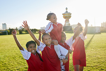 Image showing Sports. soccer and young girls with trophy celebrate, happy and excited outside on field for their victory. Team, players and female children are victorious, winners and champions for their game.