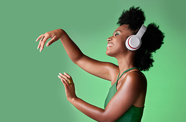 Image showing Dance, studio and black woman dancing to music in headphones while streaming happy audio sounds from a playlist. Freedom, smile and young African girl enjoying listening to radio with mockup space