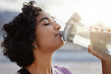 Image showing Fitness, health and sports woman drinking water to hydrate, relax and healthy energy outdoors in summer. Tired thirsty girl refreshing liquid for hydration for training, workout and running exercise