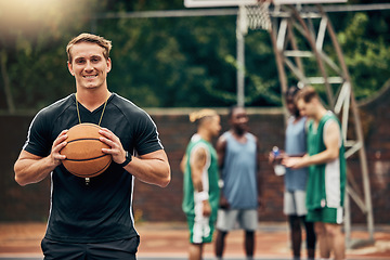 Image showing Outdoor basketball court, coach and happy man portrait training, collaboration and sports for college athlete team, professional player and fitness group. Proud, smile and teaching expert game skills