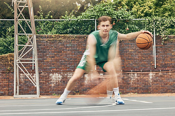 Image showing Basketball, sport and fitness with a sports man training, exercising or speed dribbling on a court with motion blur effect. Exercise, workout and health with a fast athlete playing a game outside