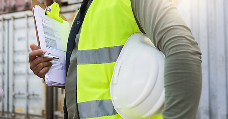 Image showing Man, checklist and work in logistics with helmet by container at port. Black man, notes and pen in hand to check stock while working in shipping, cargo and transportation industry in Cape Town