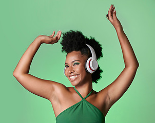 Image showing Green screen music, radio dance and black woman with smile while streaming podcast against a mockup studio background. Happy and smile African person with dancing energy from audio with headphones