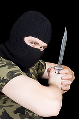 Image showing The criminal with a knife in a black mask