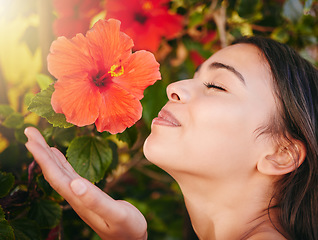 Image showing Beauty woman, smelling flowers and spring season in a garden or nature park to relax and smell tropical flower on a tree outside. Smile of a happy female enjoying her vacation holiday in Hawaii