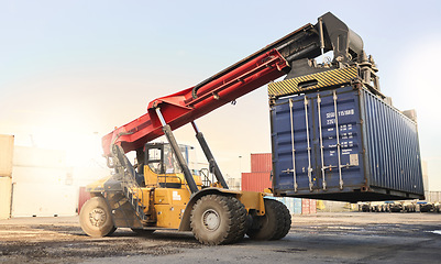 Image showing Transport, logistics and supply chain with container storage and a crane vehicle on a commercial dock. Shipping, cargo and freight in an empty yard for export, import and delivery of goods or service