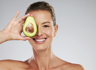Image showing Avocado skincare, woman beauty and natural cosmetics for facial mask, healthy diet and happy results on grey studio background. Portrait of mature model, organic anti aging dermatology and clean face